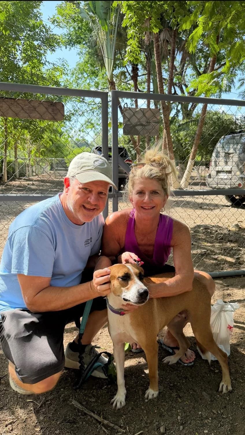 Happy adopters with their new dog